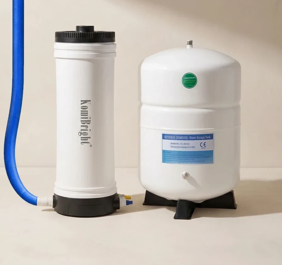 A KomiBright KB-C25R filter housing standing beside its pressure tank, with the blue feed hose running down into the fitting at its base.